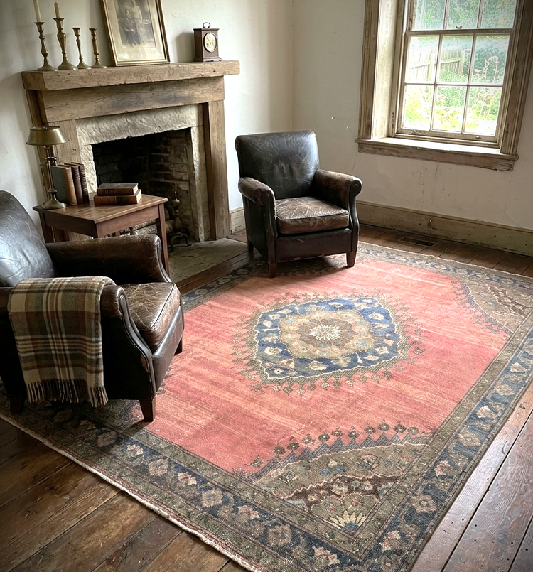 Vintage Turkish rug featuring traditional geometric motifs, warm earth tones, and a classic border design